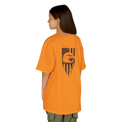 Person wearing an orange t-shirt with a graphic design on the back, standing against a white background