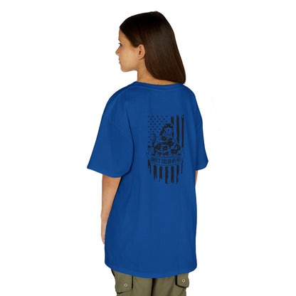 Person wearing a blue t-shirt with a graphic design on the back, standing against a white background