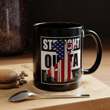 Black mug with American flag design and text on a wooden surface with coffee beans and a spoon.