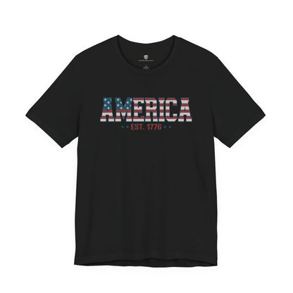 Black t-shirt with 'AMERICA EST. 1776' text on a white background