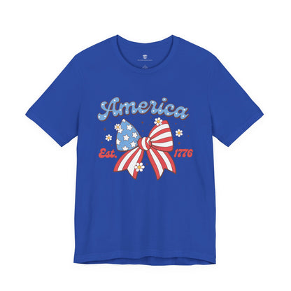 Blue t-shirt with a patriotic design featuring a bow and 'America' text on a white background