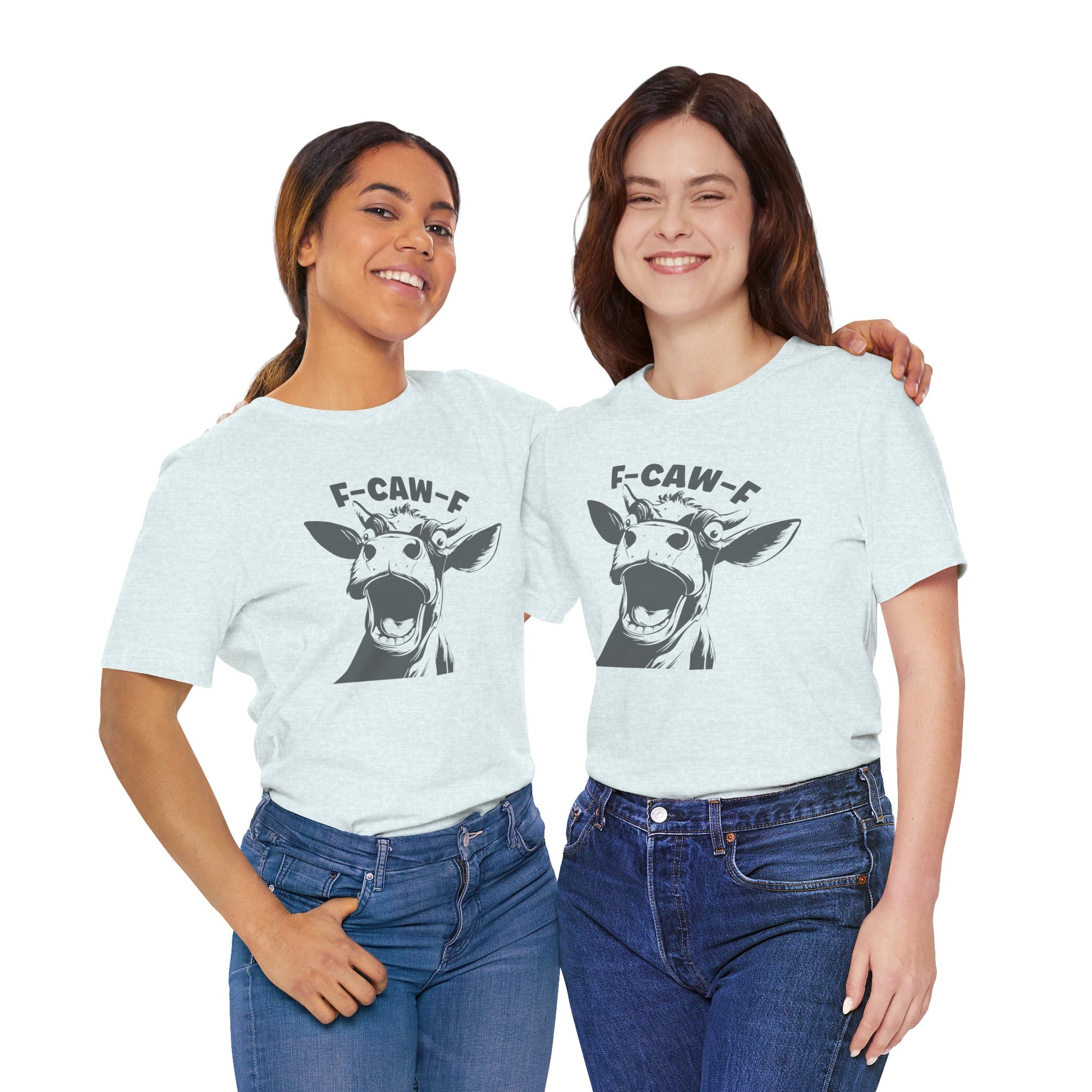 Two women wearing light blue t-shirts with a cow graphic and text.
