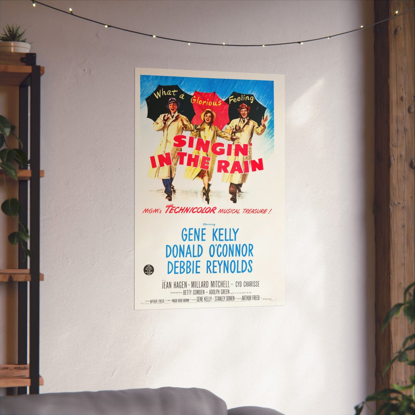 Movie poster for 'Singin' in the Rain' hanging on a wall in a room with plants and a shelf.