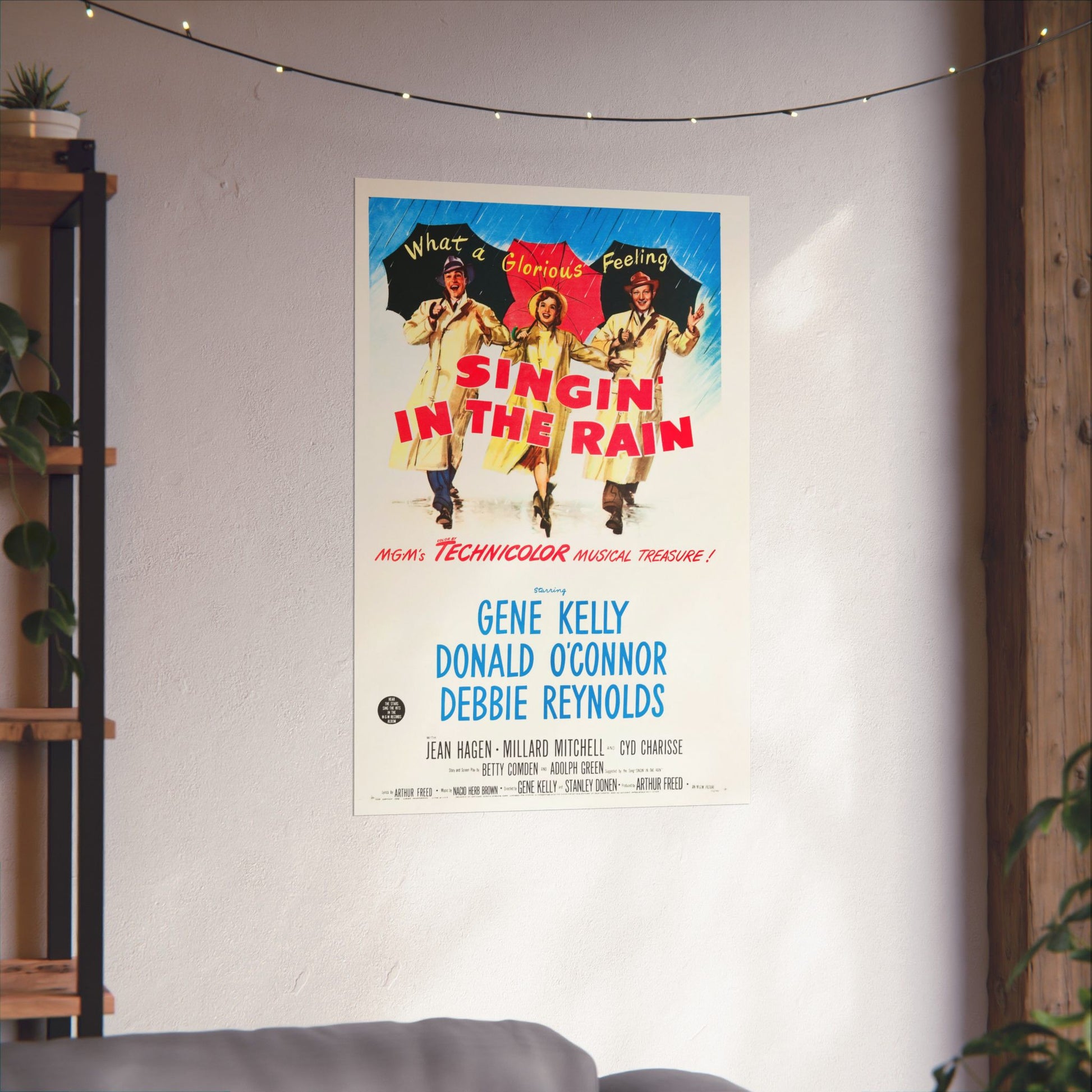 Movie poster for 'Singin' in the Rain' hanging on a wall in a room with plants and a shelf.