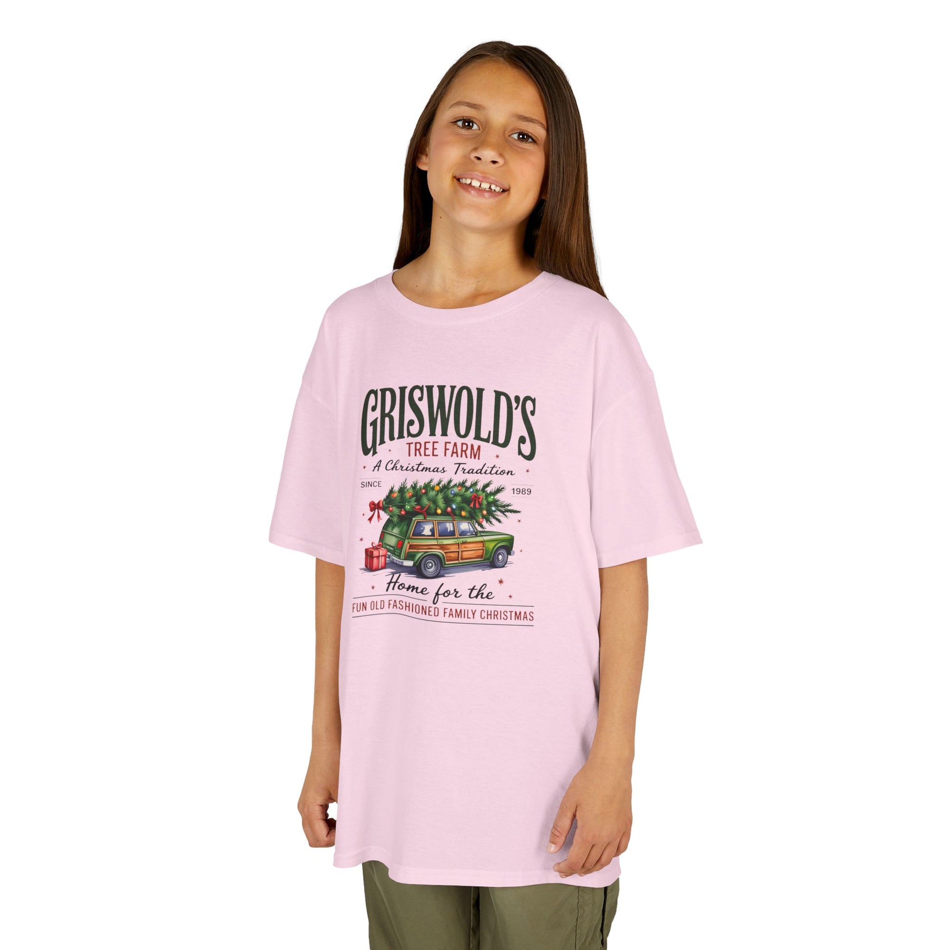 Child wearing a pink t-shirt with graphic and text on a white background