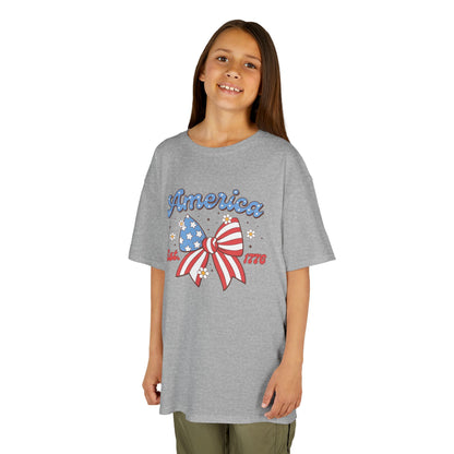 Girl wearing a gray t-shirt with 'America' and a bow design on a white background
