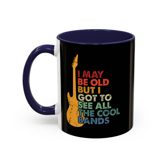 Black mug with colorful text and guitar design on a white background