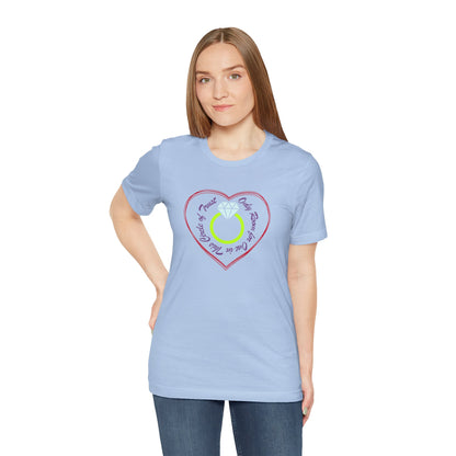 Woman wearing a light blue t-shirt with a heart and ring design on a white background