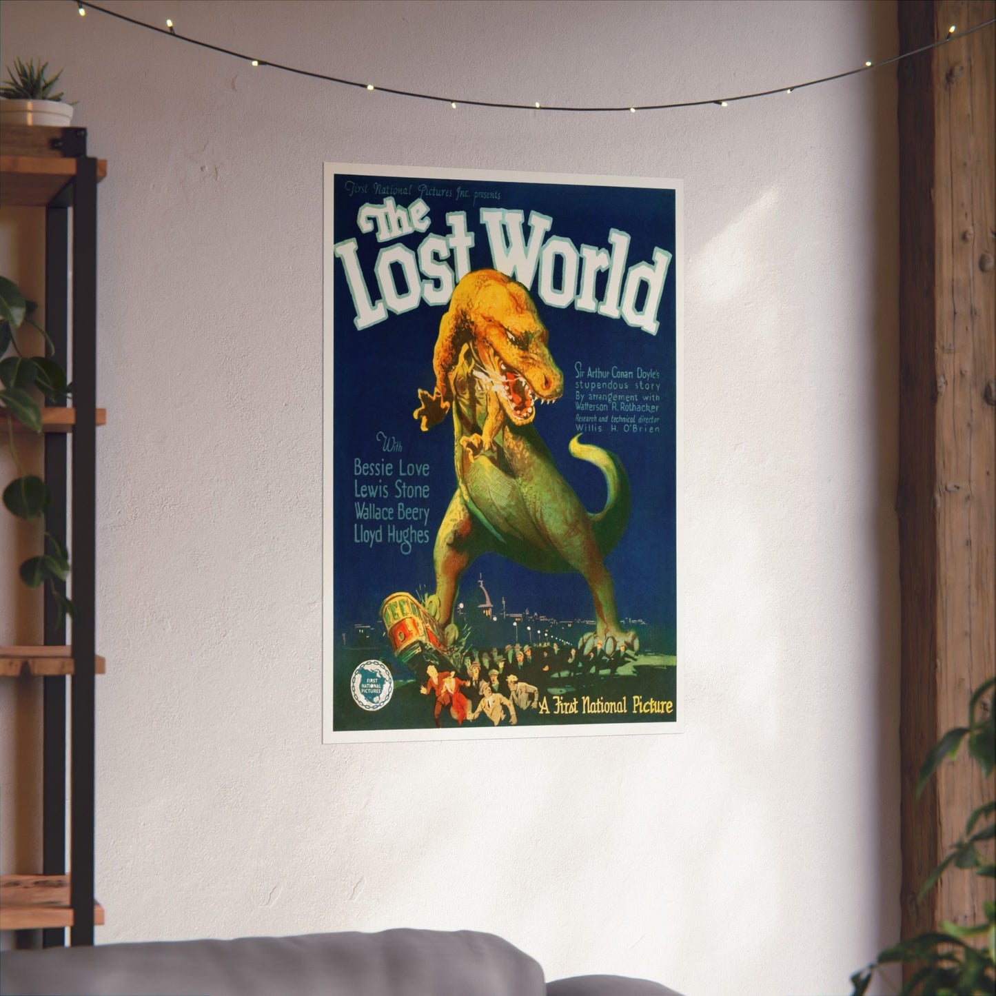 Vintage 'The Lost World' movie poster on a wall with decorative lights and plants.