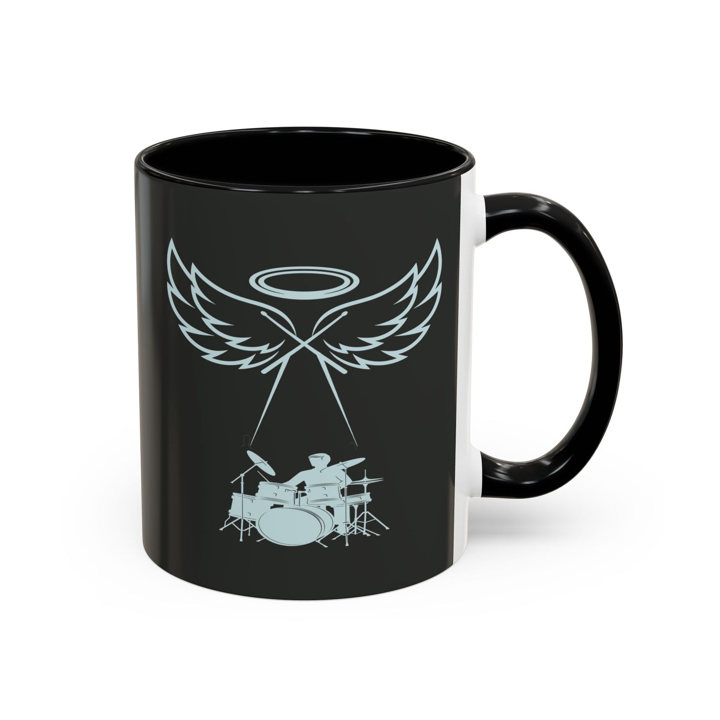 Black mug with a design of wings, a halo, and a drum set on a white background