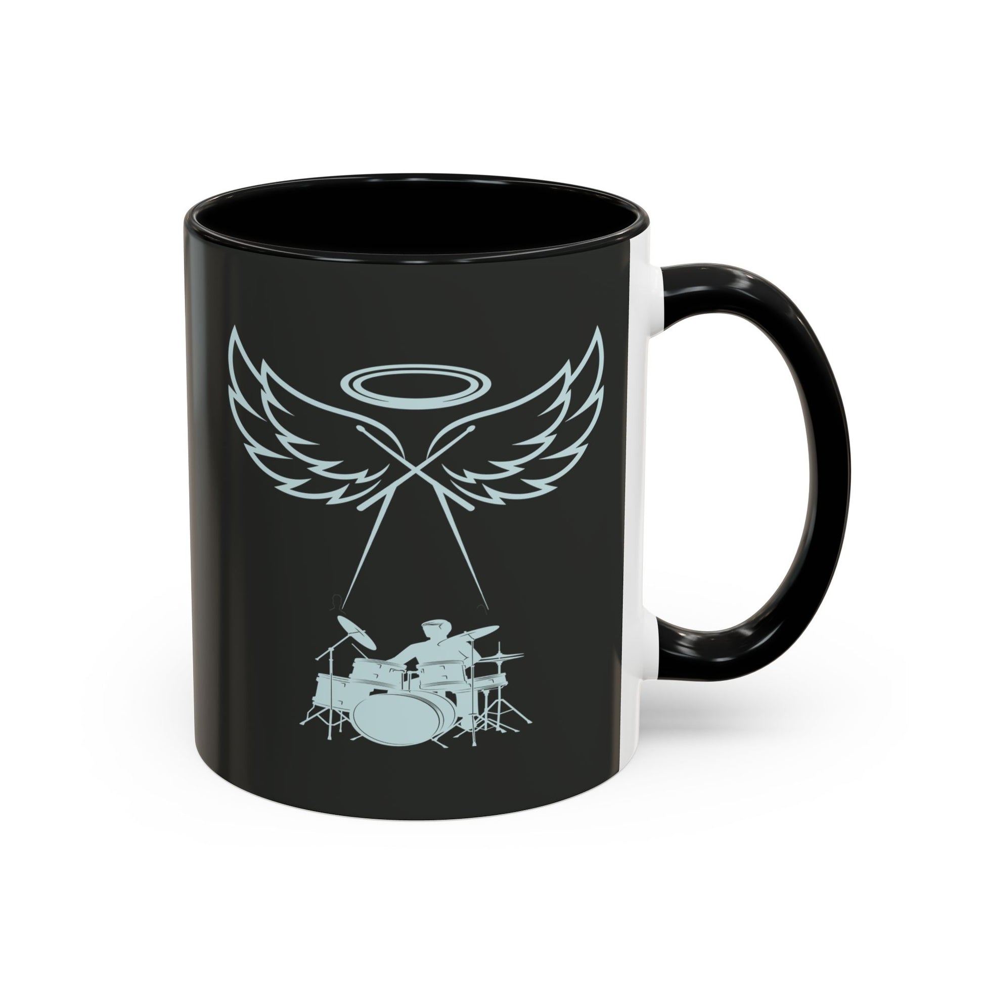 Black mug with a design of wings, a halo, and a drum set on a white background