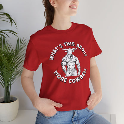 Person wearing a red t-shirt with a graphic and text, sitting indoors.