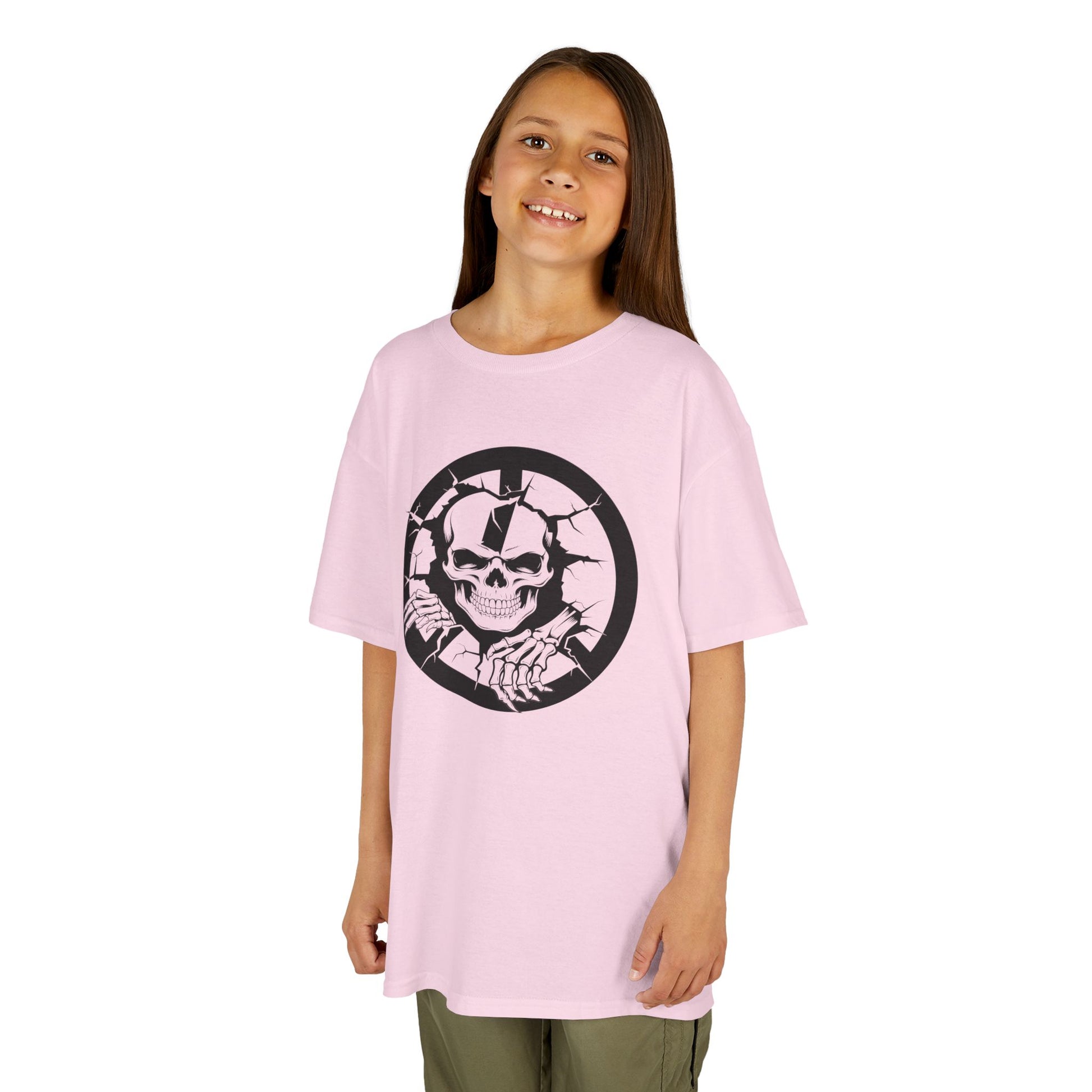 Young girl wearing a pink t-shirt with a black and white graphic design on a white background