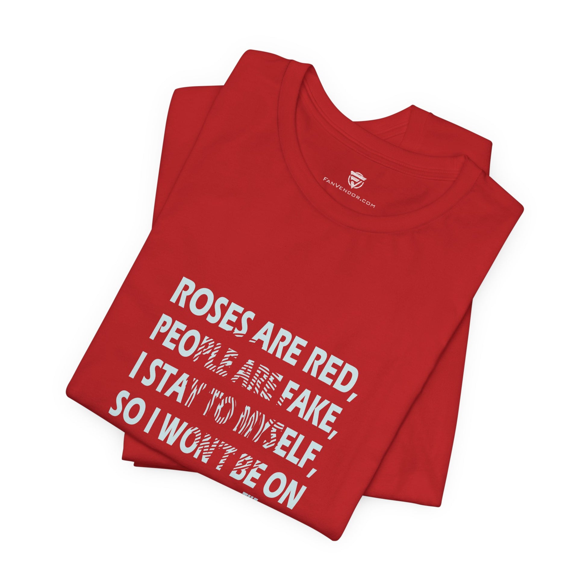 Folded red t-shirt with white text on a white background