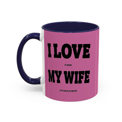 Pink mug with blue handle featuring text on a white background
