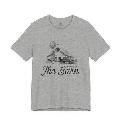 Gray t-shirt with a graphic of a barn and truck, and text 'I'd rather be at The Barn'