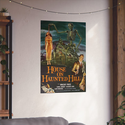 Movie poster for 'House on Haunted Hill' hanging on a wall in a room with a couch and string lights.