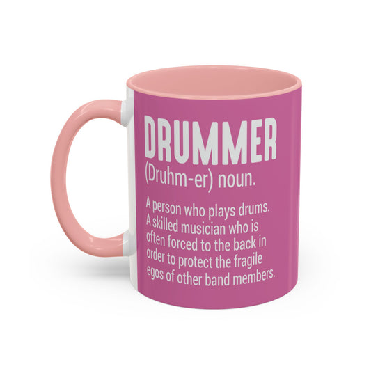 Pink mug with white text defining a drummer on a white background