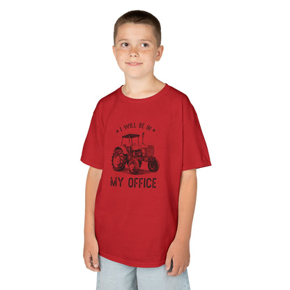 Child wearing a red t-shirt with a tractor graphic and text on a white background