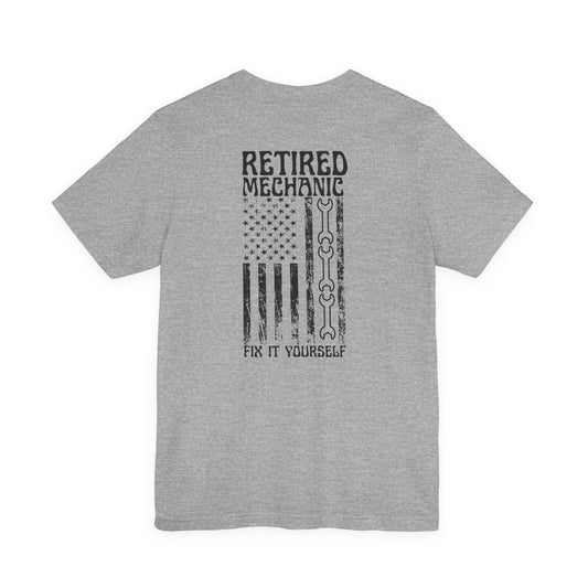 Gray t-shirt with 'Retired Mechanic Fix It Yourself' text and American flag design on a white background