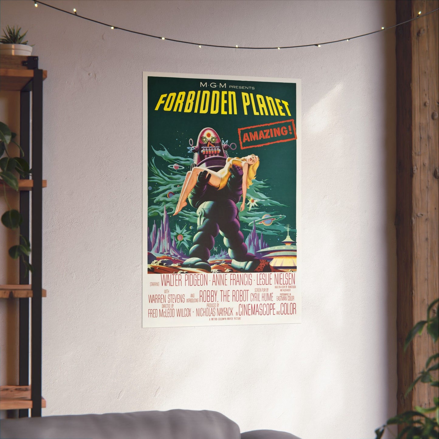 Forbidden Planet poster on a wall in a room with a shelf and plants.