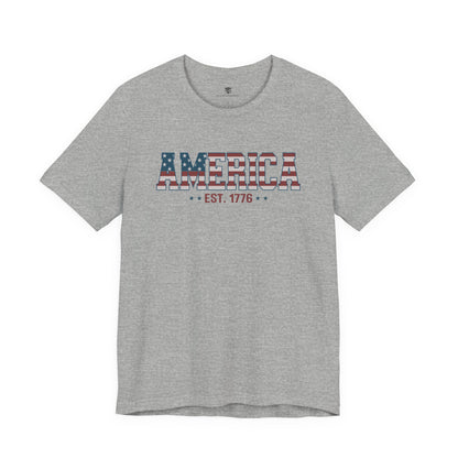 Gray t-shirt with 'AMERICA EST. 1776' text on a white background