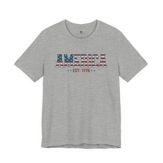 Gray t-shirt with 'AMERICA EST. 1776' text on a white background