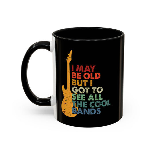 Black mug with colorful text and guitar design on a white background