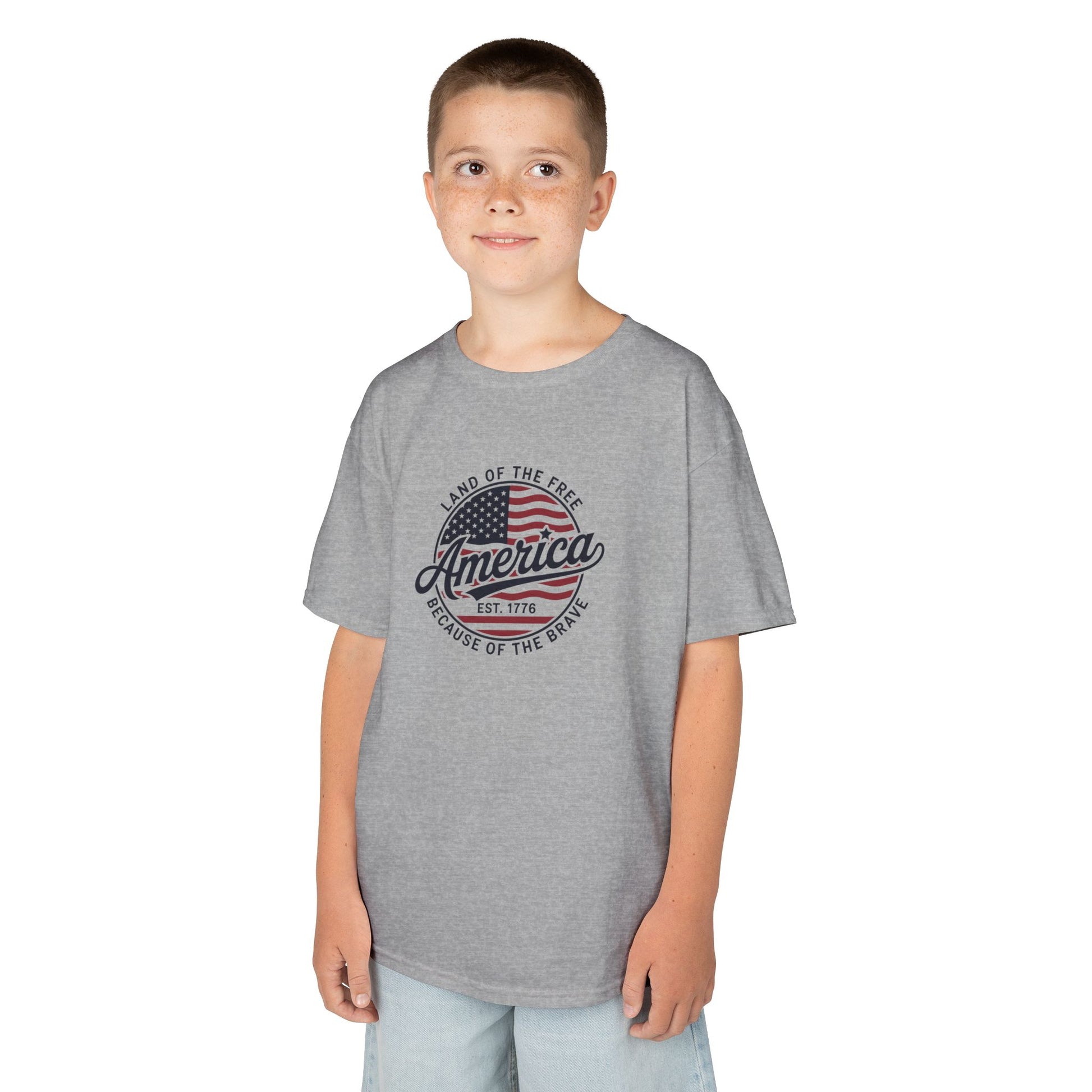 Child wearing a gray t-shirt with an American flag design on a white background