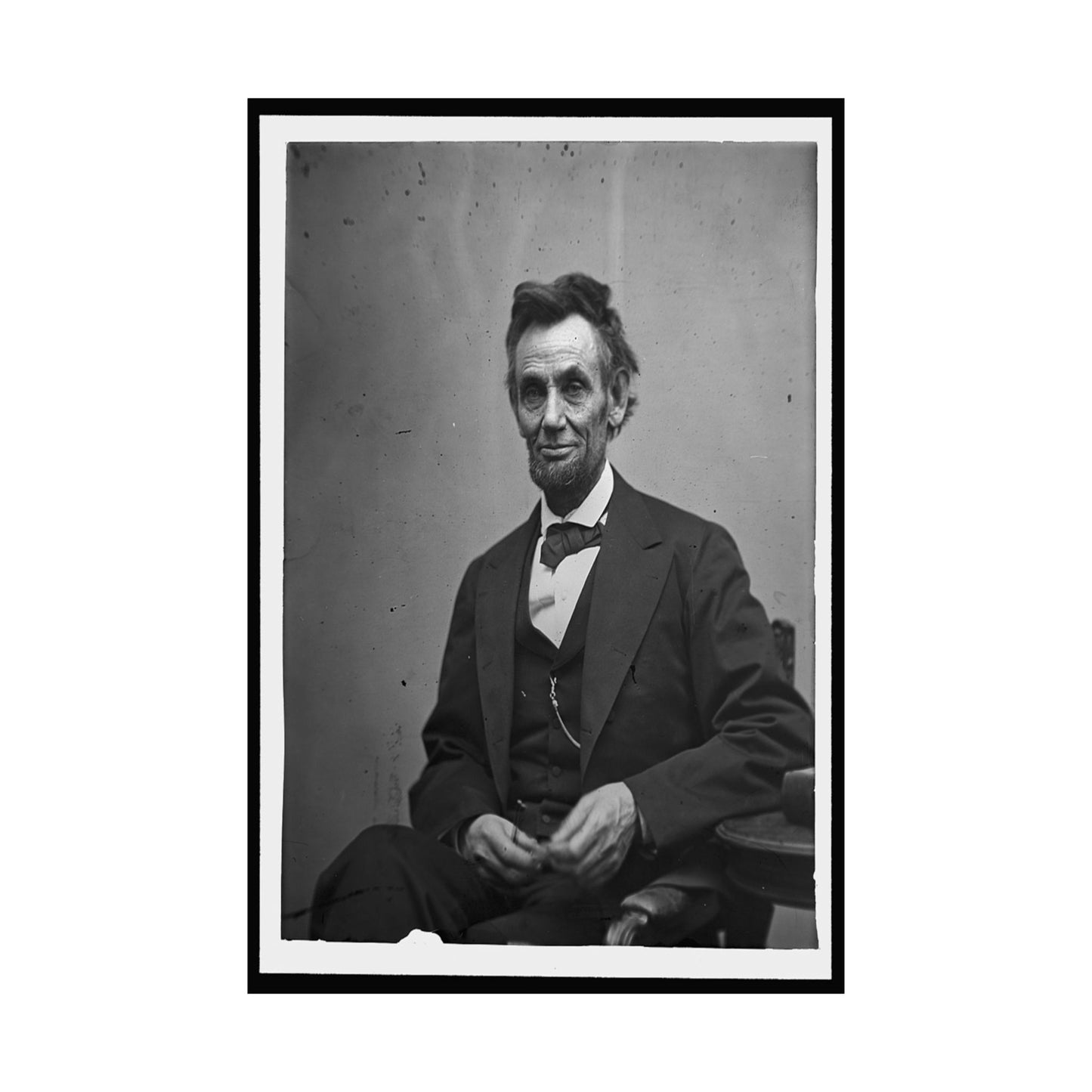Black and white portrait of a man in formal attire against a plain background