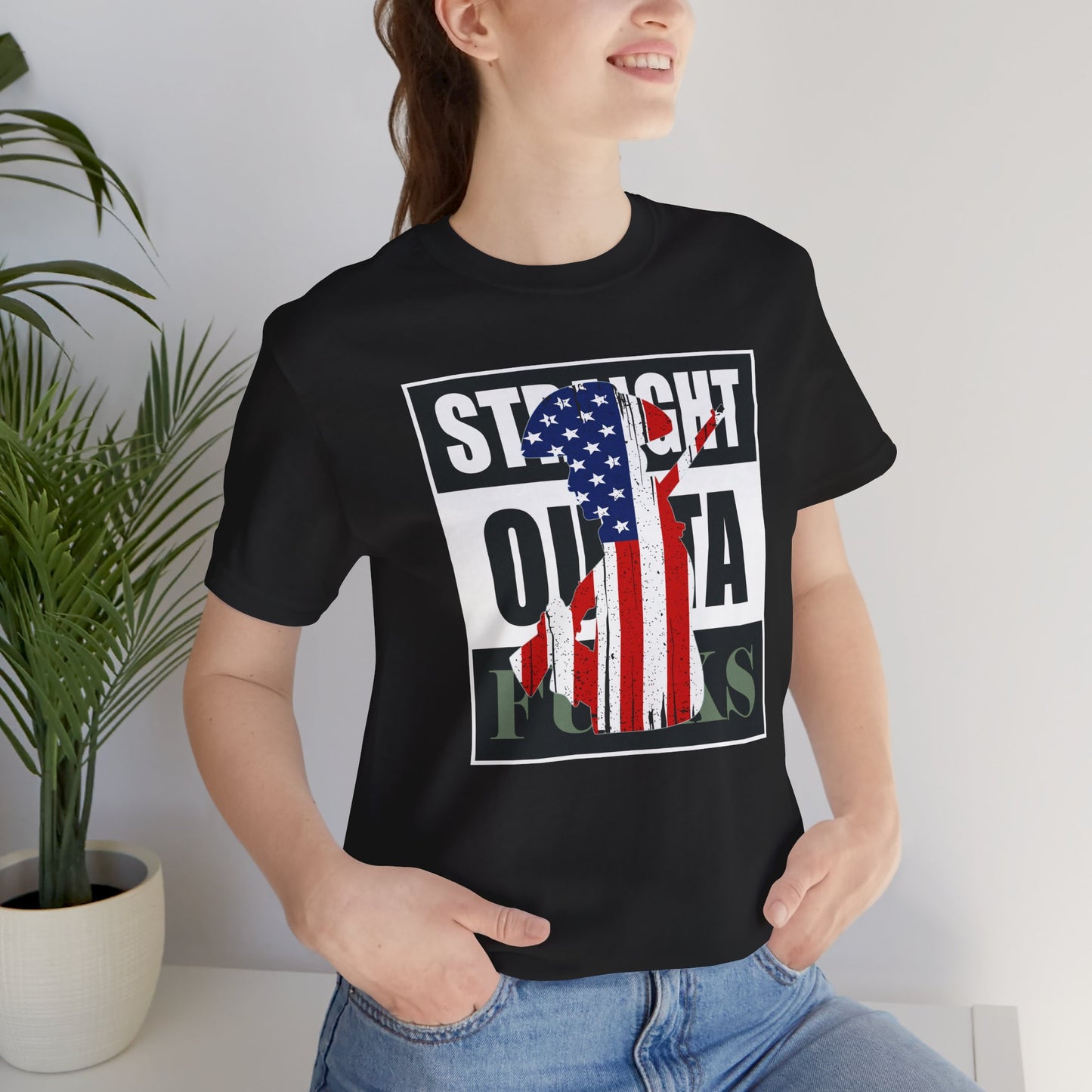 Person wearing a black t-shirt with a graphic design featuring an American flag.