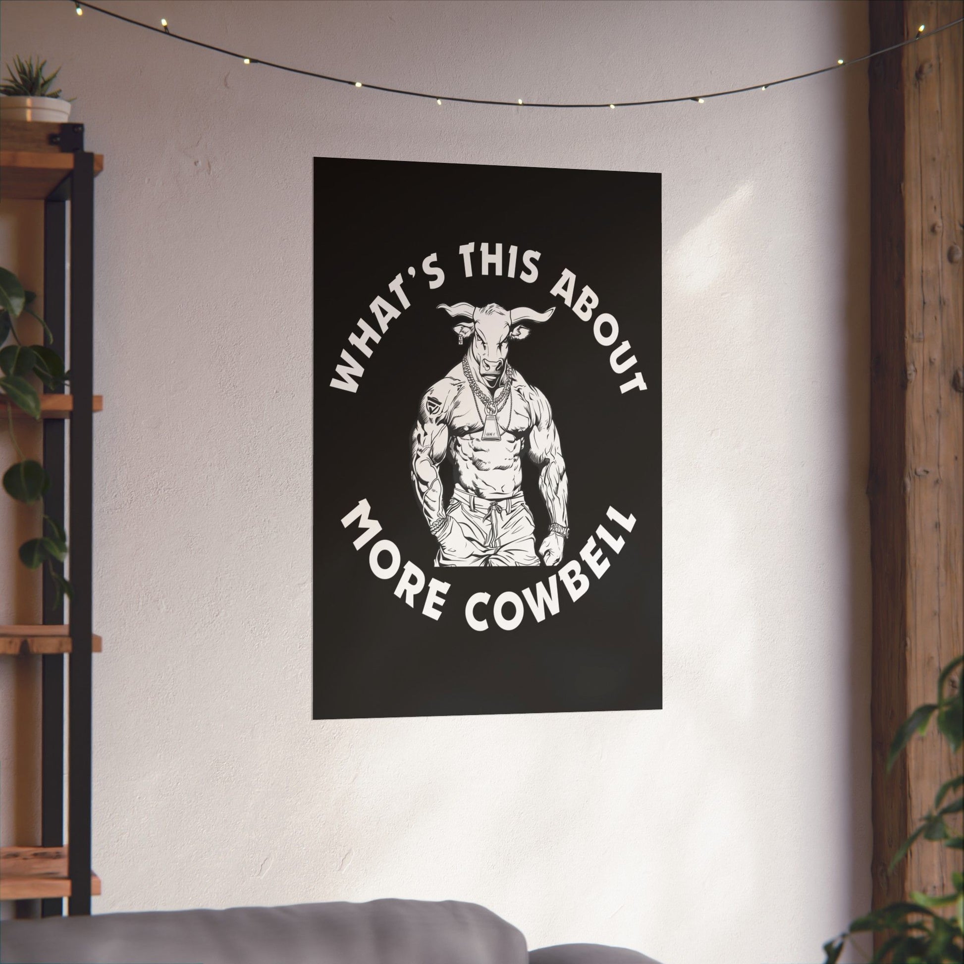 Poster with a graphic of a muscular figure and text 'What's This About More Cowbell' on a wall.
