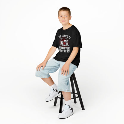 Young person sitting on a stool wearing a black t-shirt with a graphic design and light blue jeans.