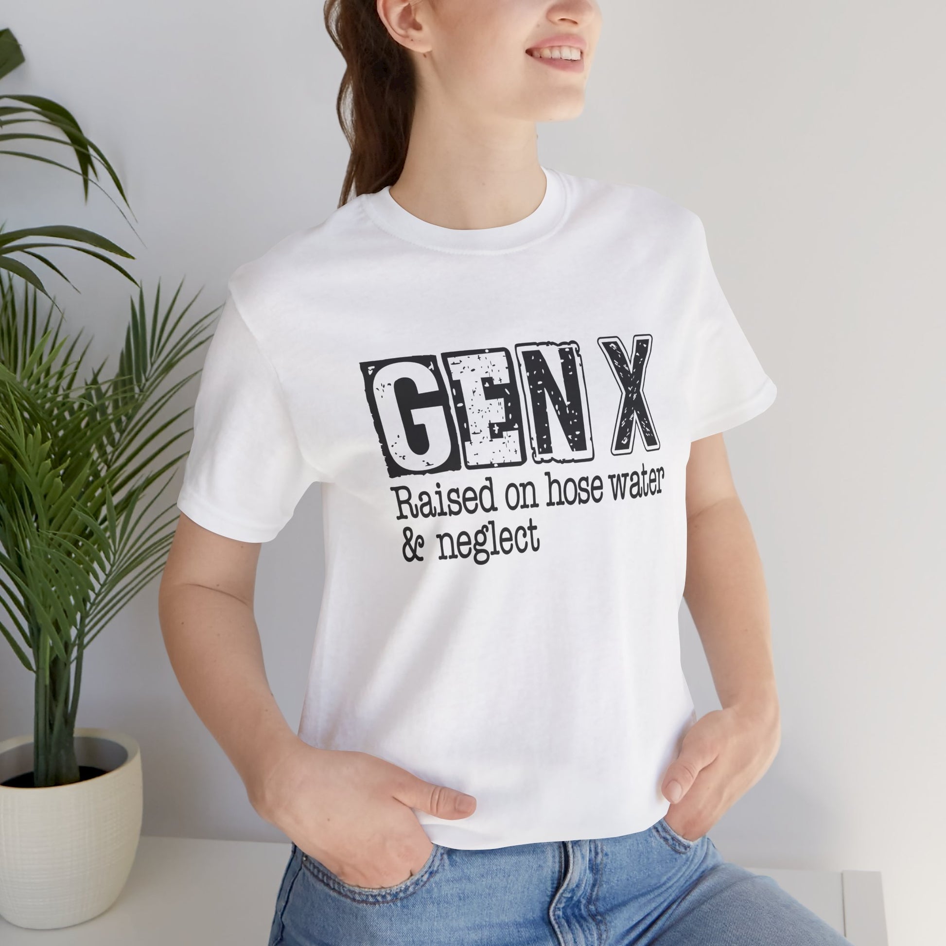 Person wearing a white t-shirt with 'GEN X Raised on hose water & neglect' text, standing indoors.