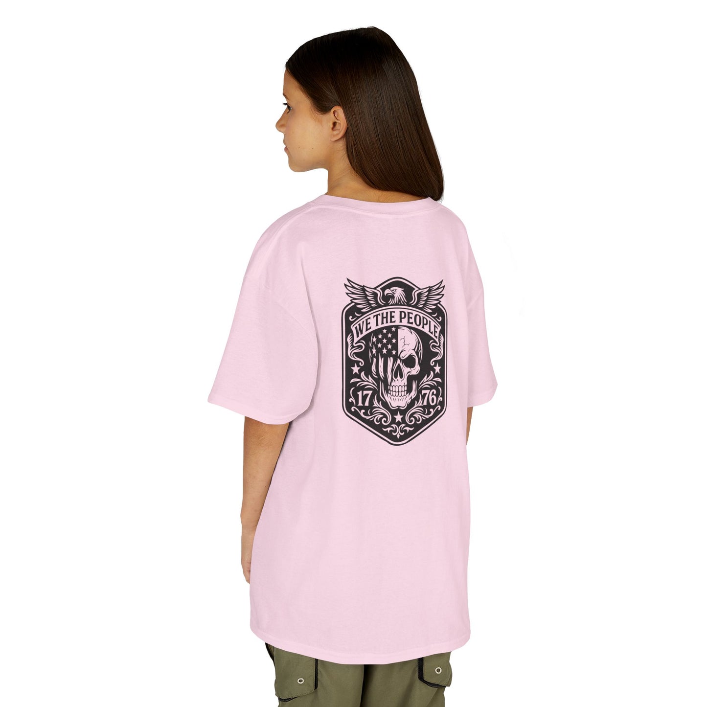 Person wearing a pink t-shirt with a graphic design on the back, standing against a white background