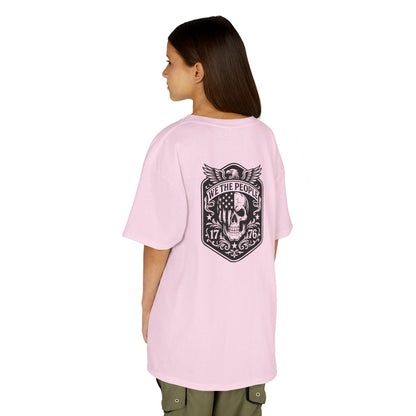 Person wearing a pink t-shirt with a graphic design on the back, standing against a white background