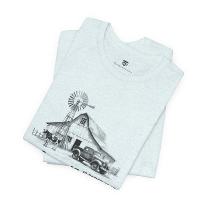 Stack of t-shirts with a graphic design of a barn and windmill 
