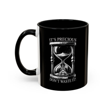 Black mug with hourglass design and text on a white background