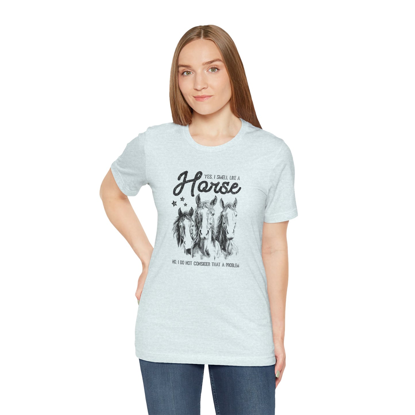 Woman wearing a light blue t-shirt with horse graphic and text 