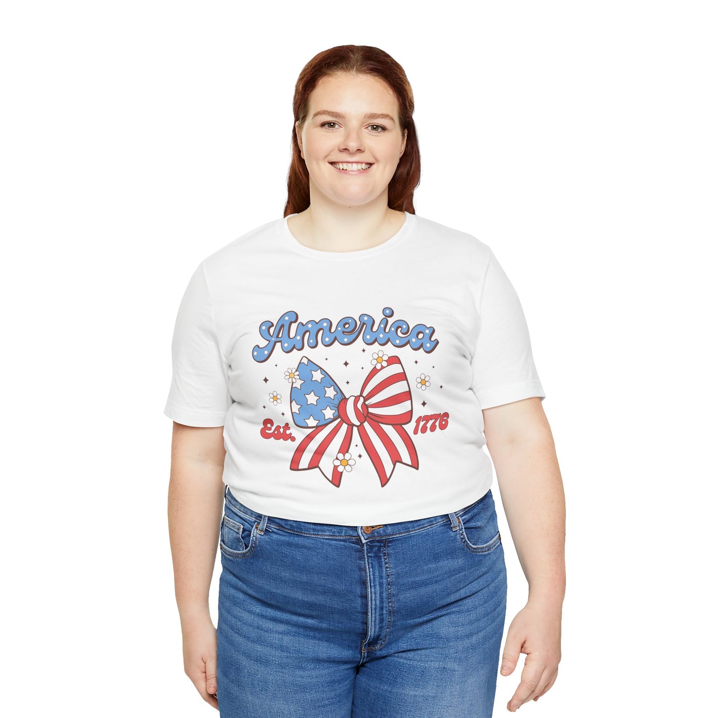 Person wearing a white t-shirt with 'America' and a bow graphic on a white background