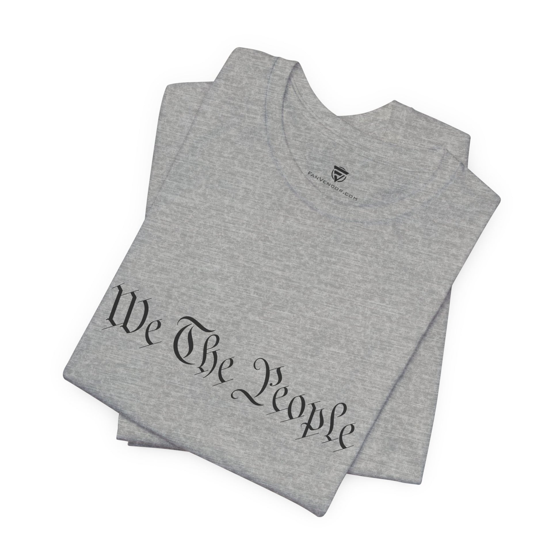 Gray t-shirt with 'We The People' printed on it, folded and displayed against a white background