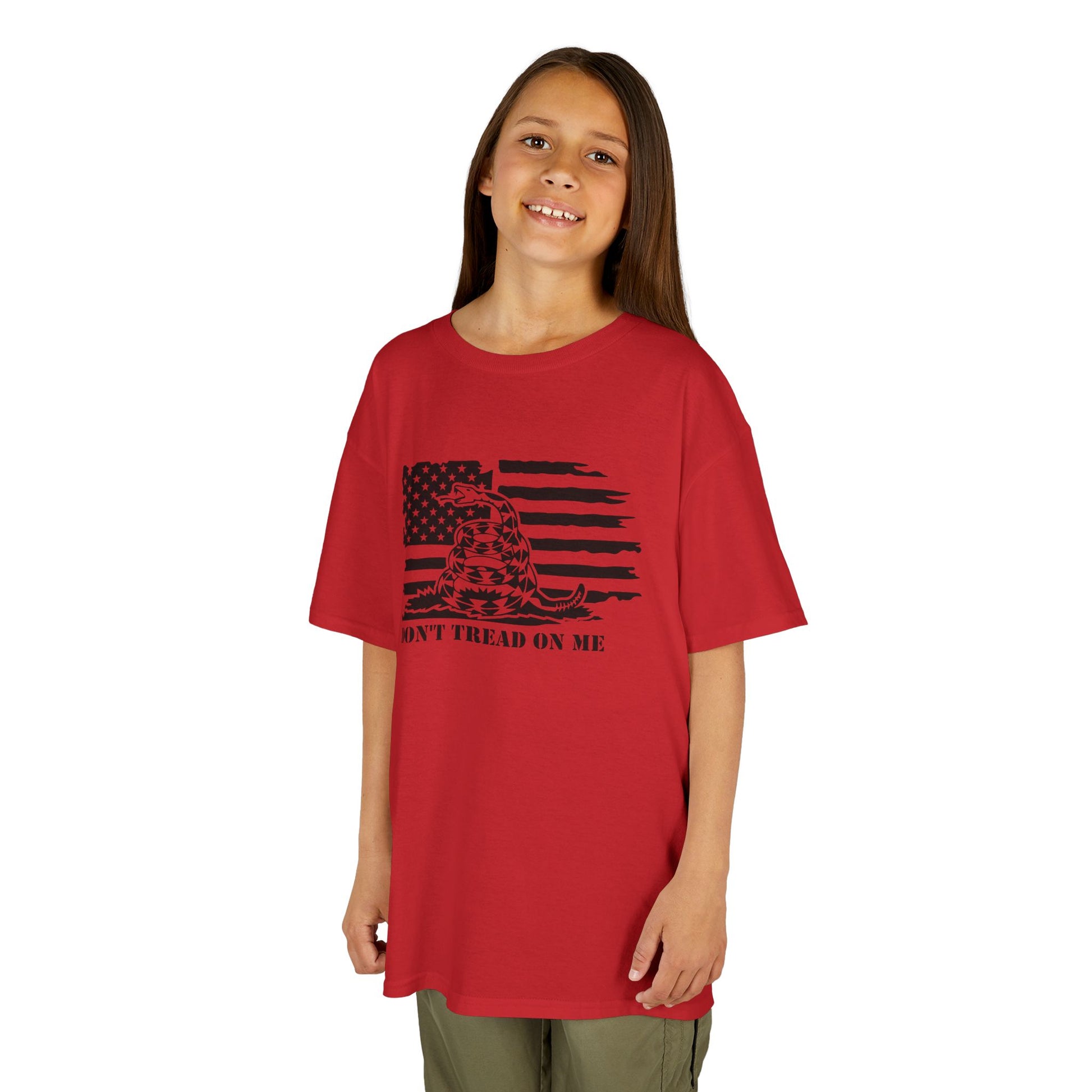Child wearing a red t-shirt with a black graphic design on a white background