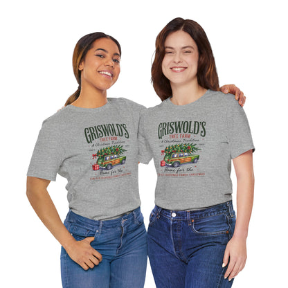 Two people wearing gray t-shirts with a Christmas-themed graphic and text.