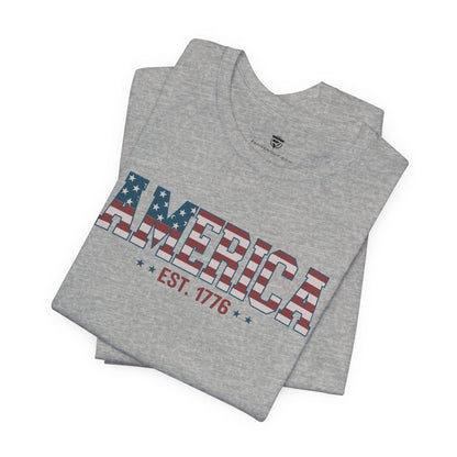 Gray t-shirt with 'America EST. 1776' design on a white background