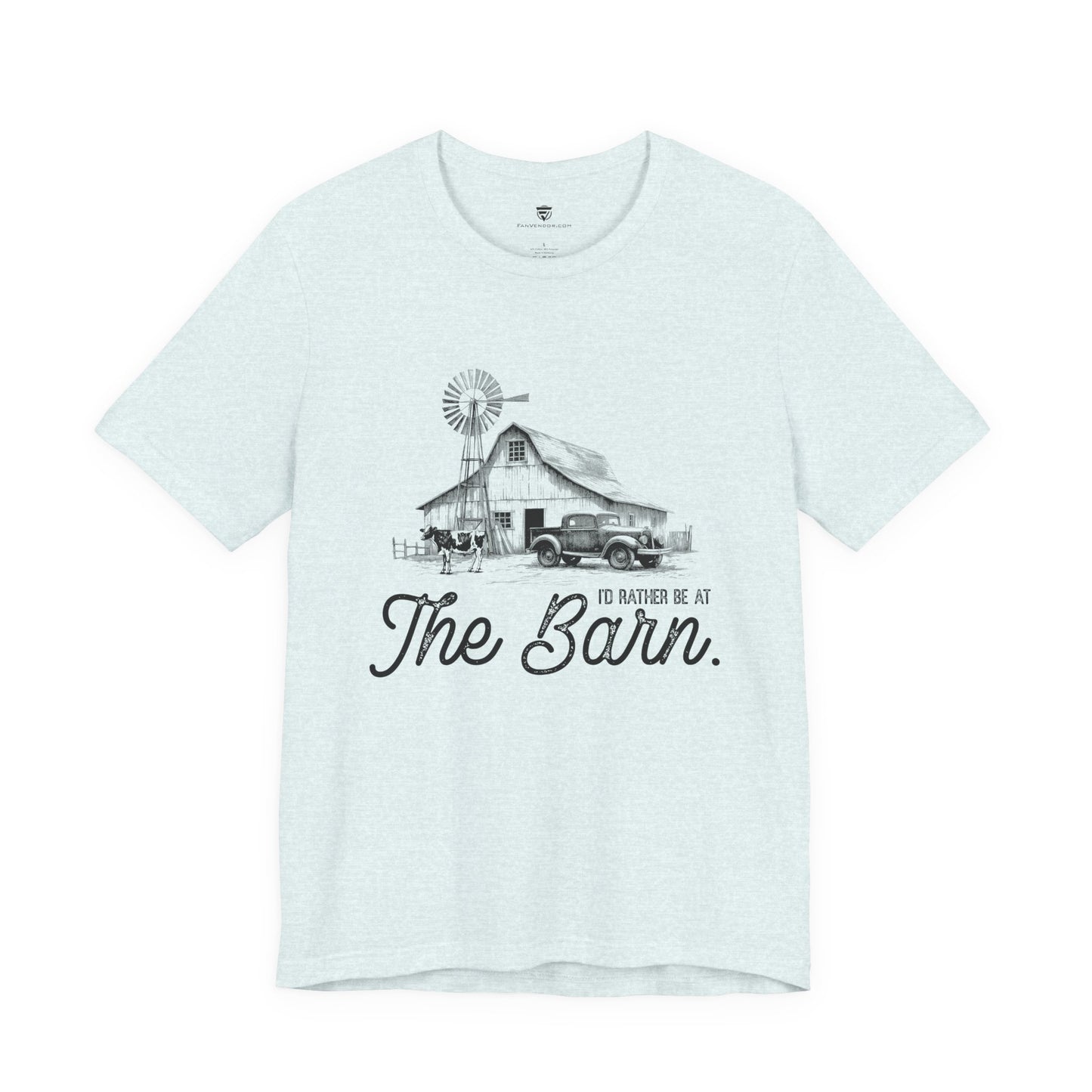 Light blue t-shirt with a graphic of a barn and truck, and text 'I'd rather be at The Barn', on a white background.