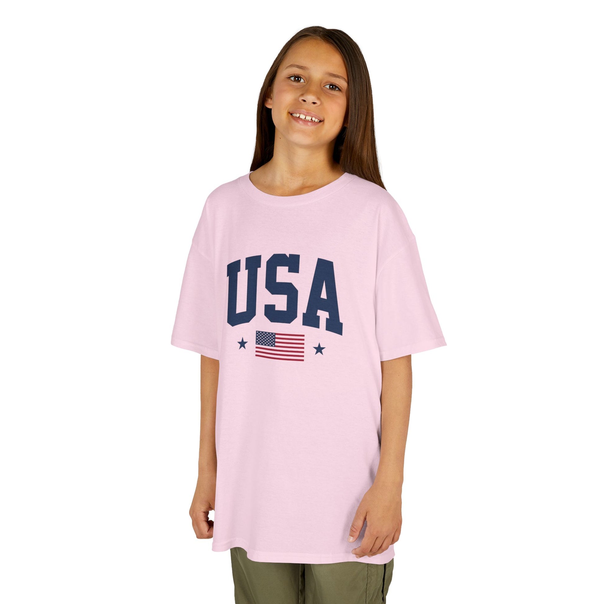 Young girl wearing a pink 'USA' t-shirt with an American flag on a white background