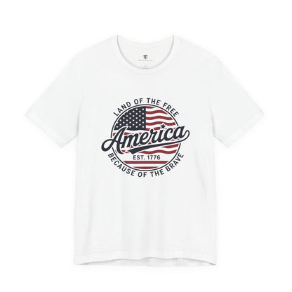 White t-shirt with American flag graphic and text on a white background