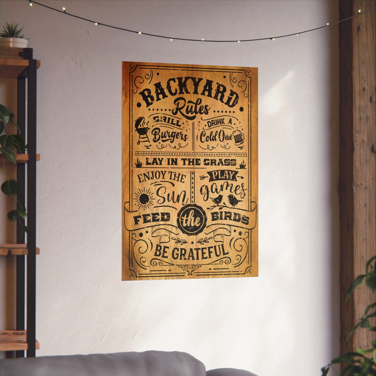 Poster with 'Backyard Rules' text on a wall in a room with plants and a shelf.