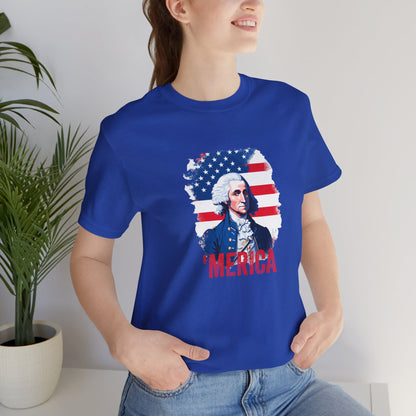 Person wearing a blue t-shirt with a graphic design and 'MERICA text, standing indoors.