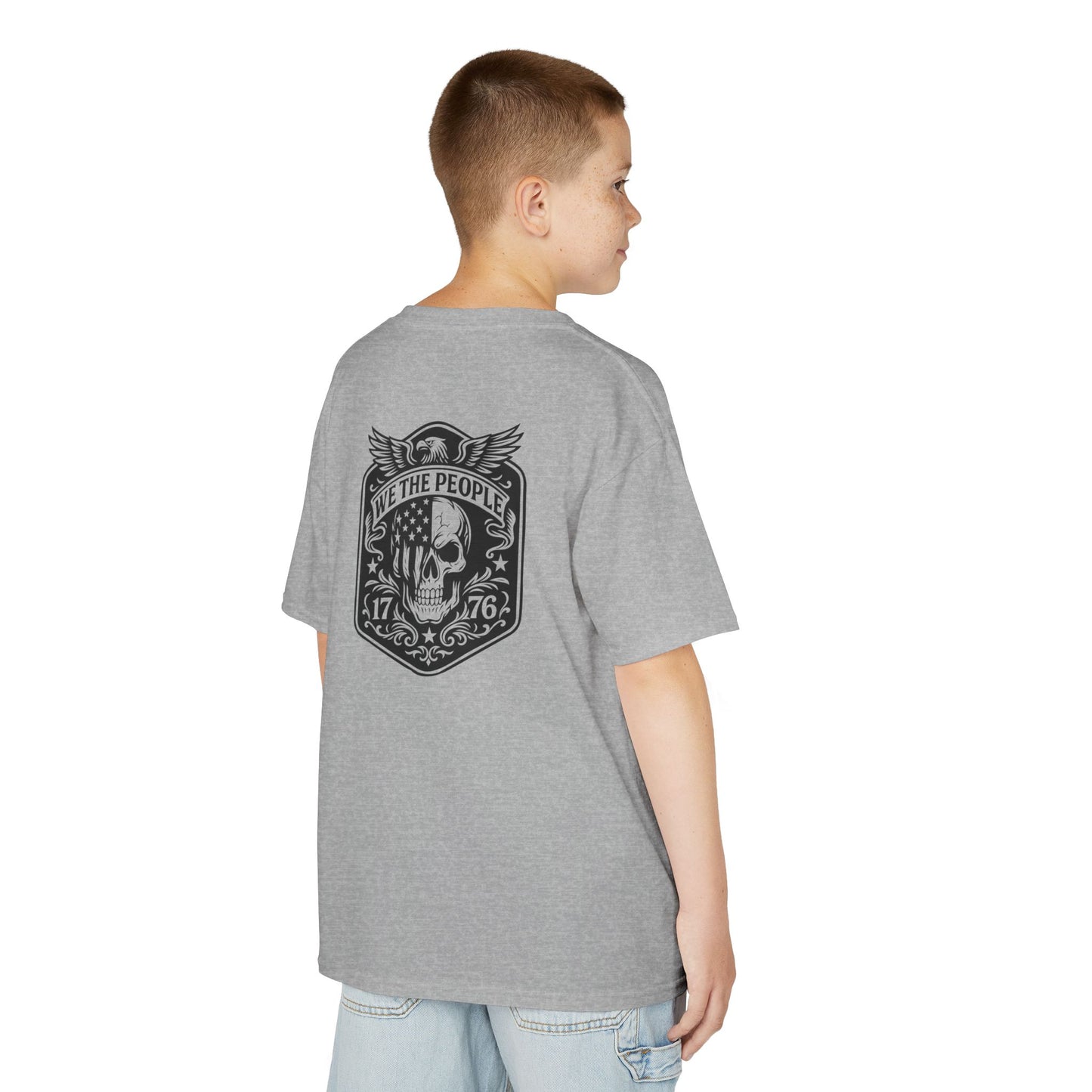 Person wearing a gray t-shirt with a skull design on the back, standing against a white background